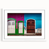 Abstract art print depicting a vibrant, colorful Central American landscape on a white-framed mat.