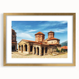 Abstract art print of a European scenery in muted gold and green tones on a framed canvas.