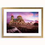 Abstract art print of a European scenery in muted gold and green hues on a framed canvas, suitable for dining room decor.