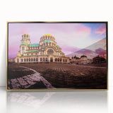 Art deco poster of a European cityscape in muted gold and blue tones, acrylic framed.