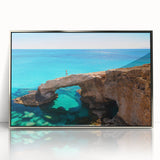 Large art print of a European Cyprus landscape in muted earth tones on a silver-framed acrylic.