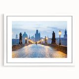 Abstract art print of a European cityscape in muted gray and blue tones on a framed white mat, ideal for dining room decor.