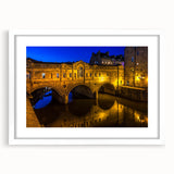 Textured art print of an abstract European cityscape in muted earth tones, framed in white, ideal for bedroom art.