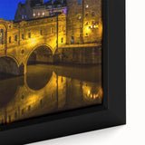 Black wall art featuring a textured depiction of a European scenery, with colorful accents.