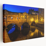 Large art depicting a serene European scenery in muted green and blue tones on stretched canvas.