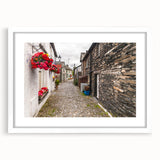 Textured art print of abstract rolling hills in muted green and blue tones, framed with a white mat, ideal for bedroom decor.