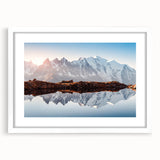 Textured art depicting the French Alps in muted gray and blue tones on a framed white mat, ideal for bedroom decor.