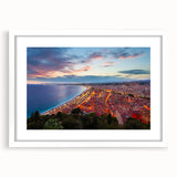Textured abstract art print depicting the Nice, France coastline in muted blue and tan tones, framed with a white mat.