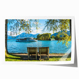 Rolled print of a Bavarian landscape with lush green fields and distant mountains, in soft green and blue tones.