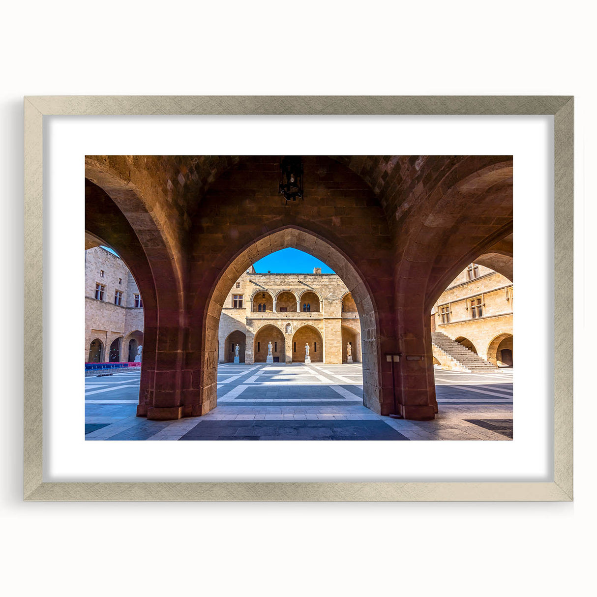 Extra large abstract art print of a European scenery in muted earth tones, framed in silver, suitable for living room decor.