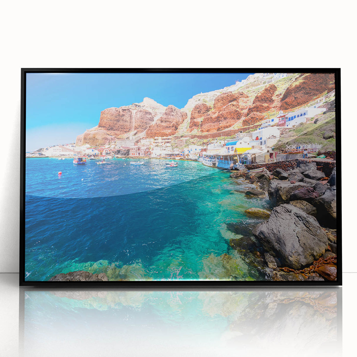 Large abstract wall art depicting the Santorini coastline in muted blue and white tones, framed in black acrylic.
