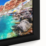 Black wall art depicting a textured Santorini scene with vibrant blue and white tones, framed canvas.