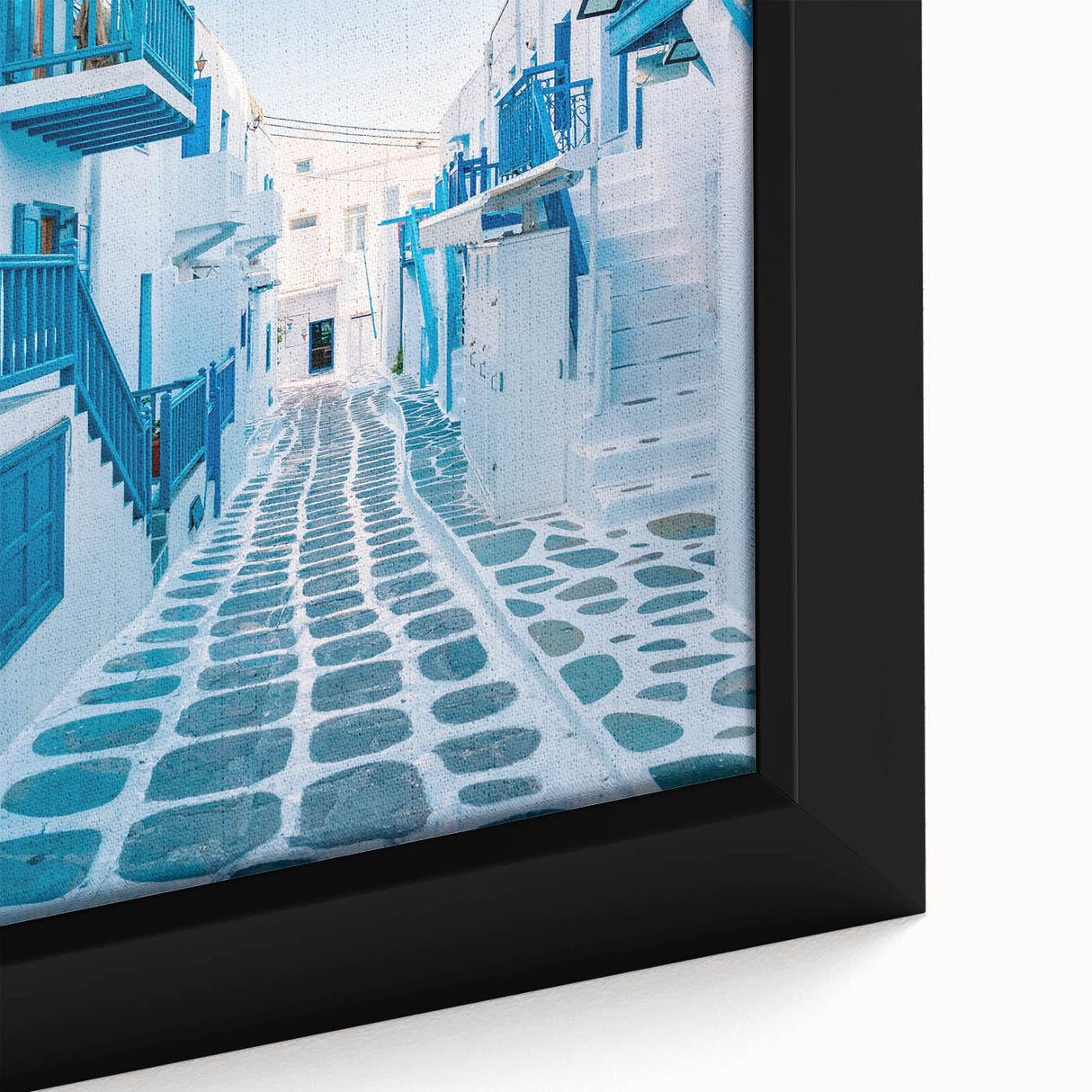Close-up of a framed canvas featuring a textured depiction of a Greek landscape in black with colorful accents.