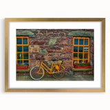 Abstract art print depicting a scenic Irish landscape in muted green and earth tones, framed in gold.