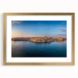 Abstract art print of a European Malta scenery in muted blue and cream tones, framed in gold, ideal for dining room decor.