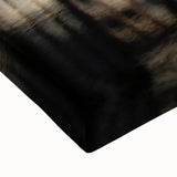 Large art depicting a black and white Amsterdam canal scene on stretched canvas, suitable for bedroom wall placement.