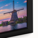 Extra large framed canvas featuring a textured depiction of a European scenery in black with colorful accents.