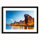 Extra large abstract art print of a colorful European scenery on textured canvas, framed in black.