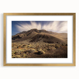 Abstract art print of a European scenery in muted gold and blue tones, framed with a gold mat.