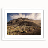 Textured abstract art print of a European scenery in muted earth tones, framed with a white mat, suitable for bedroom decor.