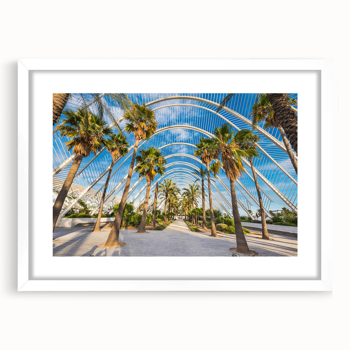 Abstract art print of Valencia scenery in muted orange and blue tones, framed with a white mat.