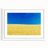 Abstract art print of a European landscape in muted blue and green tones, framed with a white mat.