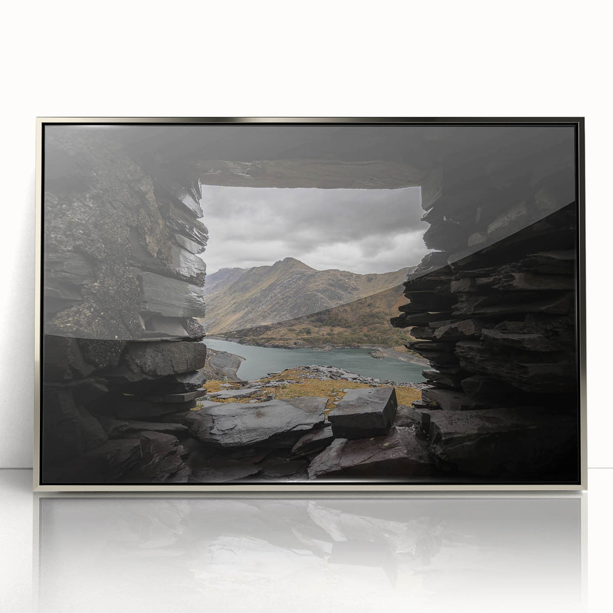 Mid-century modernist art depicting a serene Welsh landscape in muted green and blue tones, framed acrylic.