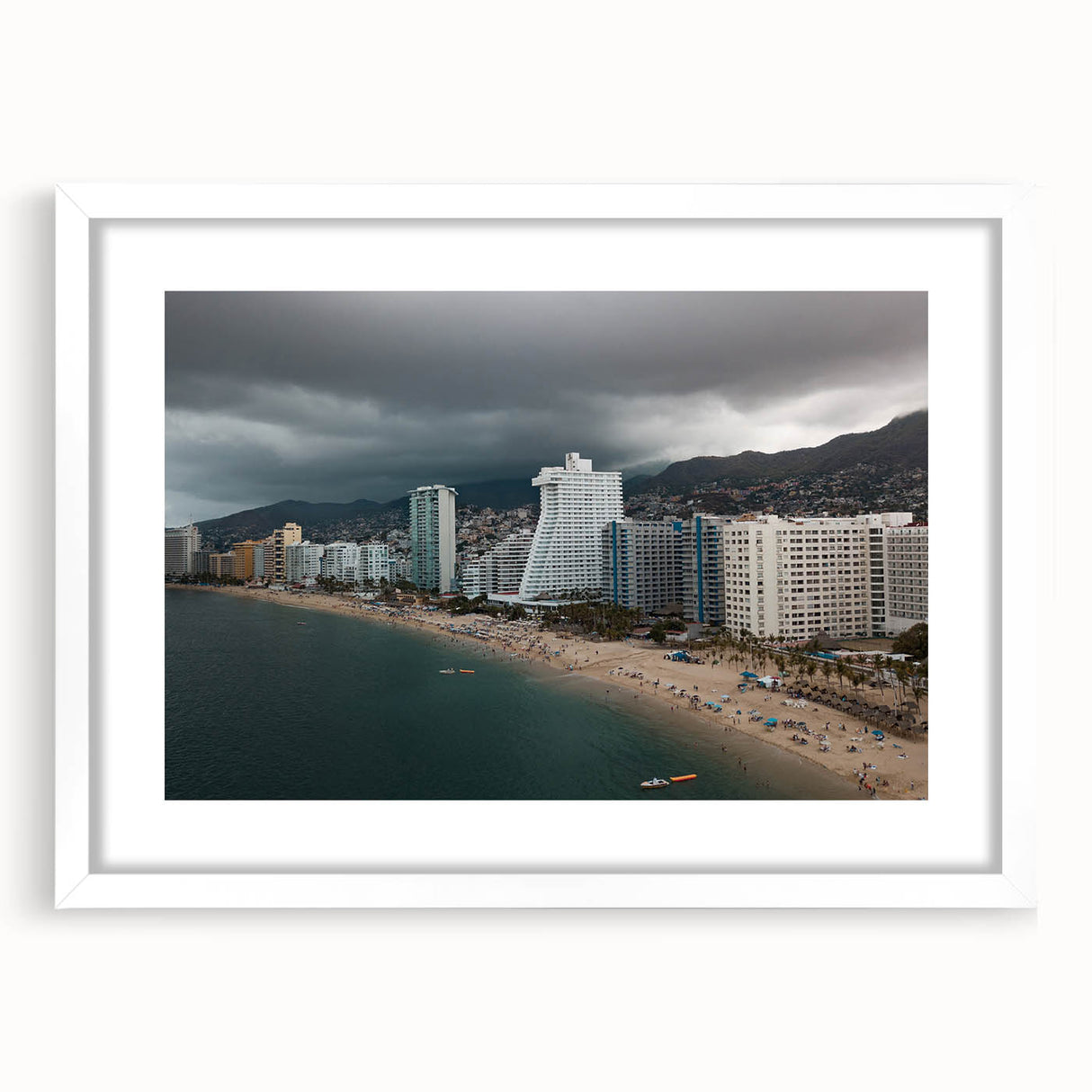 Abstract art print of Acapulco scenery in muted blue and white tones, framed with a white mat, ideal for dining room decor.