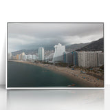 Art deco poster of Acapulco scenery in vibrant colors, framed in white acrylic.