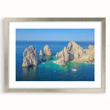 Textured abstract art print of Cabo San Lucas with muted earth tones on a framed silver mat, suitable for bedroom decor.