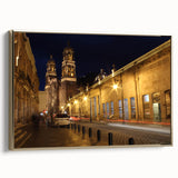 Framed canvas of a vintage-style Mexico City landscape in muted gold and black tones, suitable for bedroom decor.
