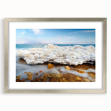 Textured art print of the Dead Sea in muted blue and gray tones, framed in silver, ideal for bedroom wall decor.
