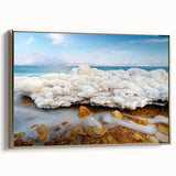 Framed canvas of the Dead Sea landscape in muted gold and black tones, suitable as wall art for a bedroom.