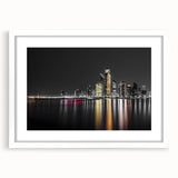 Abstract art print of Abu Dhabi skyline in muted gray and blue tones on a framed white mat, ideal for dining room decor.