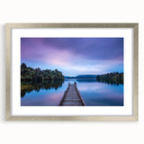 Textured art depicting an abstract ocean scene in cool blue and white tones on a framed canvas.