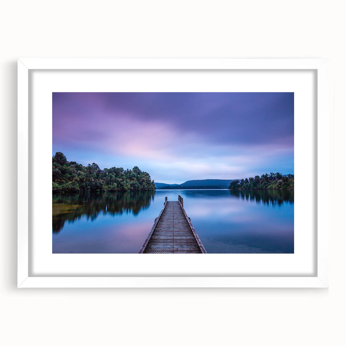 Abstract art print of New Zealand's West Coast in muted blue and green tones on a framed white mat.