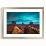 Textured art print of Monument Valley in muted earth tones, framed in silver, ideal for bedroom art.
