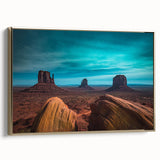 Framed canvas wall art depicting Monument Valley in muted earth tones, ideal for bedroom decor.
