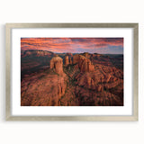 Textured art depicting abstract Sedona landscape in earthy red and orange tones, framed in silver.