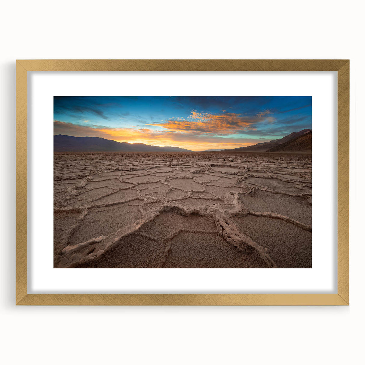 Extra large abstract art print of Death Valley in textured earth tones on a gold-framed canvas, ideal for living room decor.
