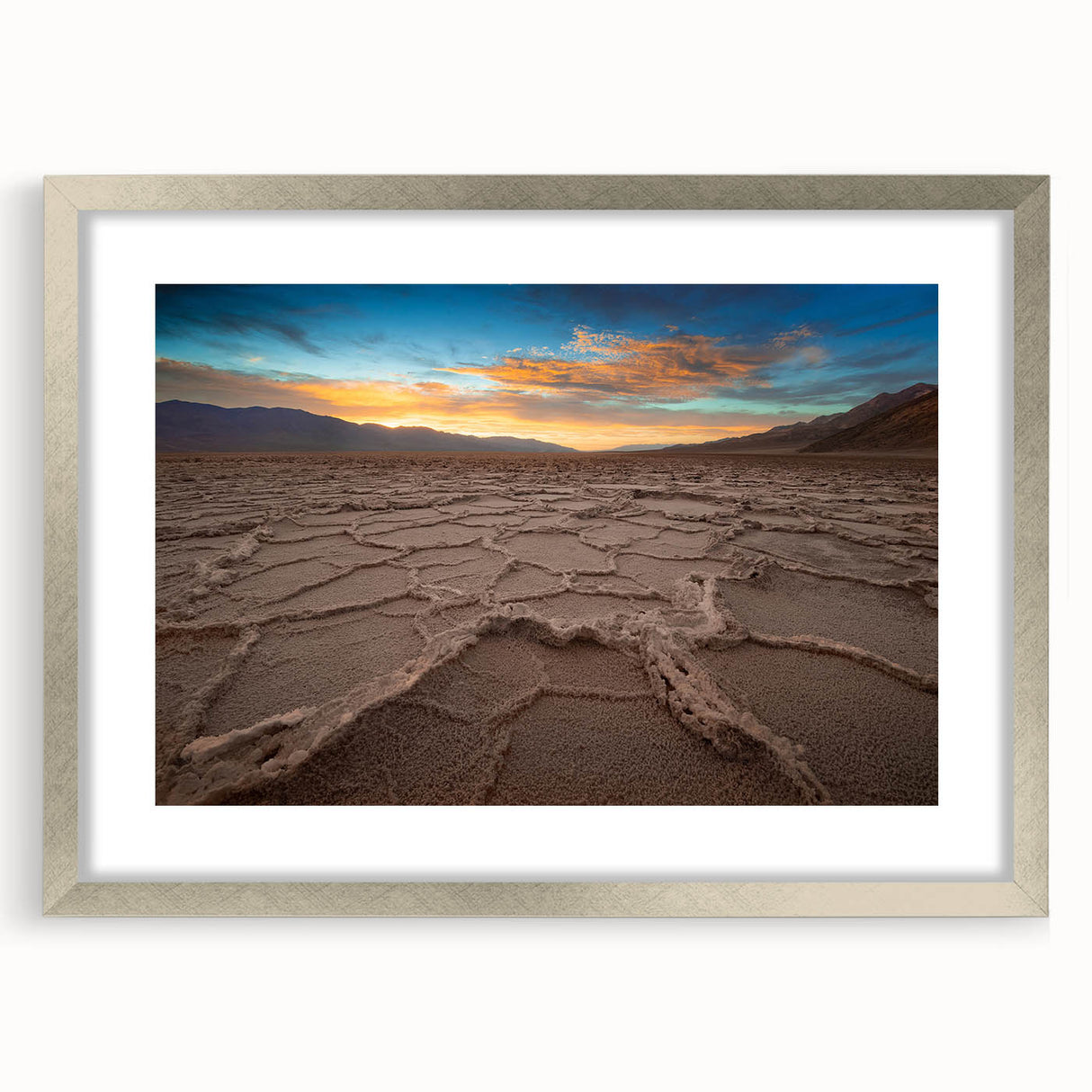 Textured art of Death Valley in muted earth tones on a silver-framed matte canvas, suited for bedroom decor.