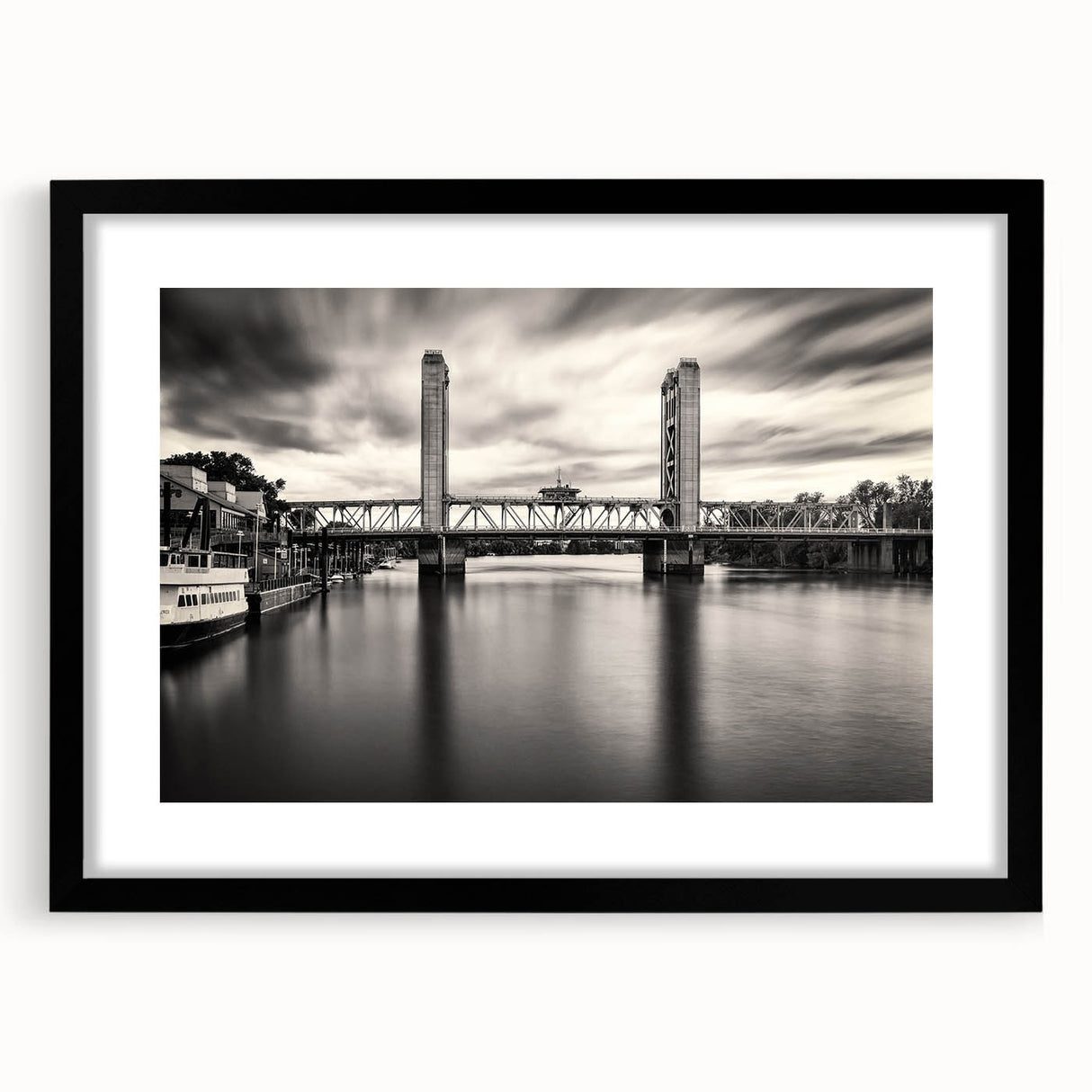 Abstract art print of Sacramento scenery in vibrant multicolor on textured canvas, framed in black.