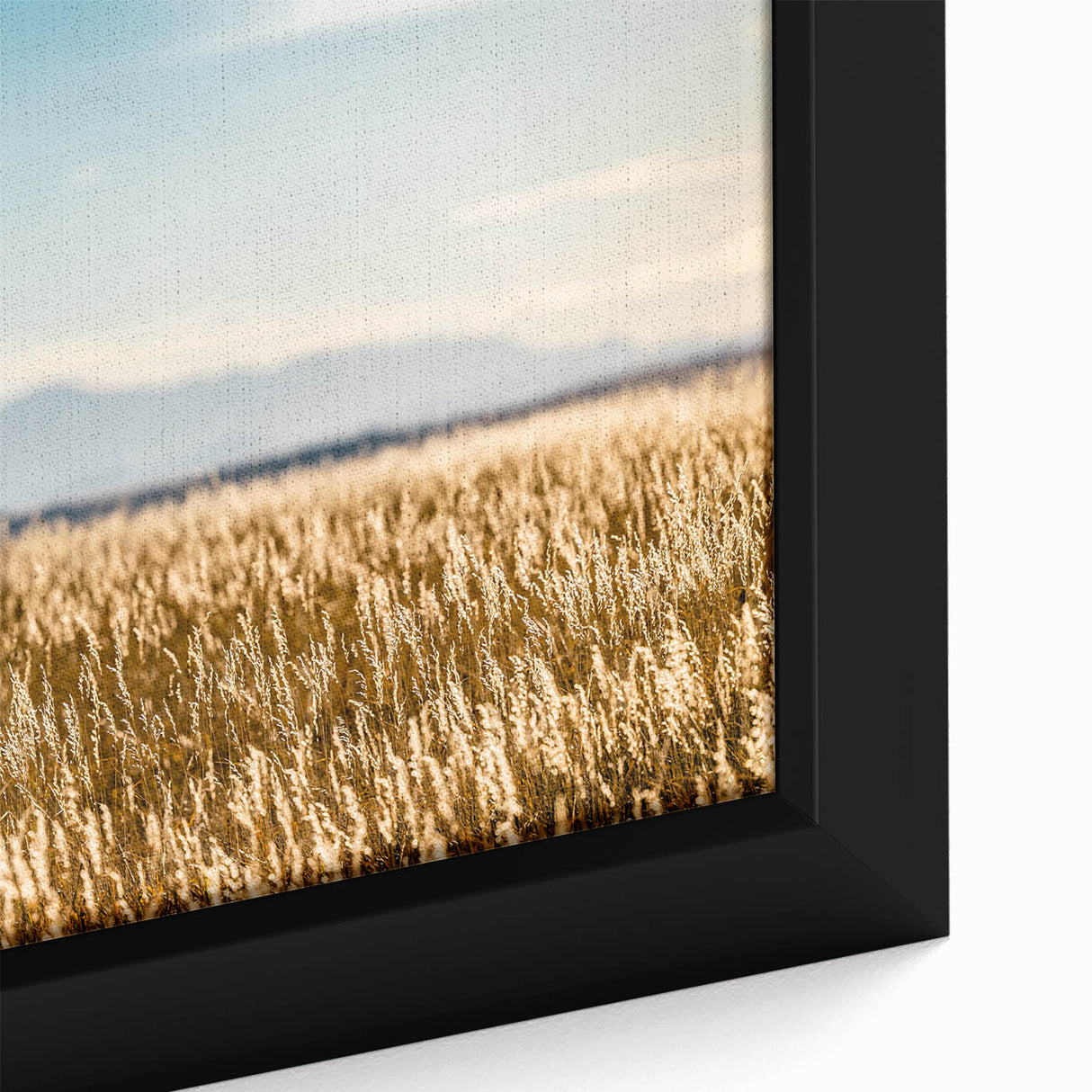 Close-up of a textured black wall art featuring a colorful Pikes Peak scenery on a framed canvas.
