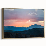 Framed canvas featuring a vintage-style landscape painting of the Rocky Mountains in muted gold and black.