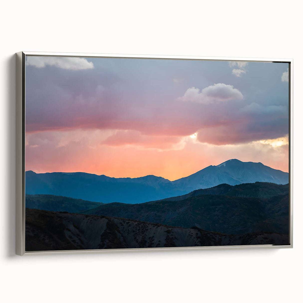Framed canvas of a Rocky Mountains landscape painting in a vintage poster style with a palette of black and vibrant colors.