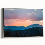 Framed canvas of a Rocky Mountains landscape painting in a vintage poster style with a palette of black and vibrant colors.