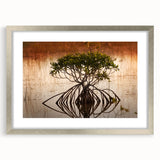 Textured art depicting an abstract depiction of the Everglades in muted green and blue hues, framed in silver.