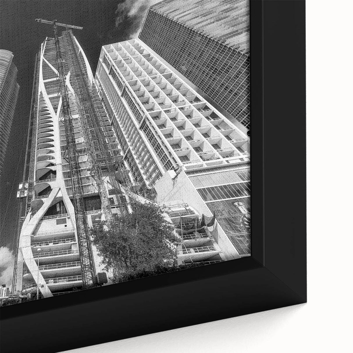 Black wall art featuring a textured depiction of Miami’s skyline in colorful hues on a large framed canvas.
