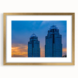 Extra large abstract art print of Atlanta skyline in muted gray and blue tones on a gold-framed canvas.
