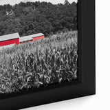 Close-up of a textured black wall art depicting Iowa scenery in colorful hues on a framed canvas.